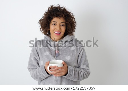 Wow. Beautiful female wearing pajama. Young emotional surprised woman standing with open mouth. Human emotions, facial expression concept. Trendy colors.