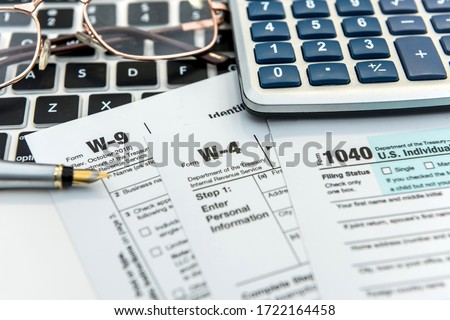 Financial time tax form with laptop and calculator. Office paperwork. Accounting Royalty-Free Stock Photo #1722164458