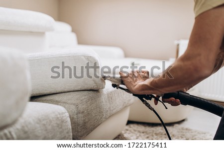 Process of deep furniture cleaning, removing dirt from sofa. Washing concept. Royalty-Free Stock Photo #1722175411