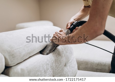 Process of deep furniture cleaning, removing dirt from sofa. Washing concept. Royalty-Free Stock Photo #1722175417