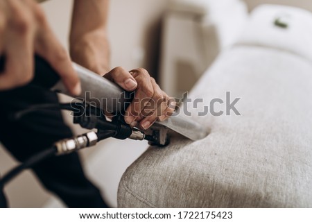 Process of deep furniture cleaning, removing dirt from sofa. Washing concept. Royalty-Free Stock Photo #1722175423