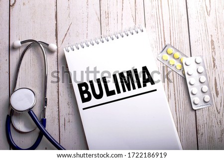 Stethoscope and pills, top view, deep background, bulimia