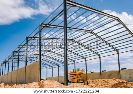 Details of the construction of a steel industrial warehouse with reinforced concrete walls Royalty-Free Stock Photo #1722221284