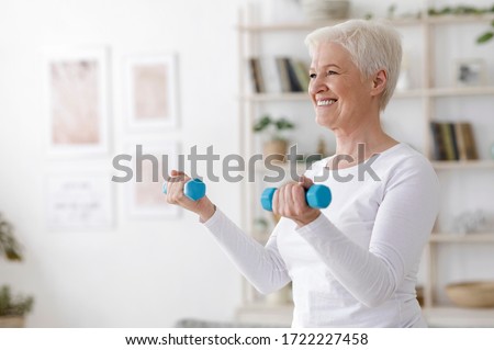 Gym At Home. Positive Aged Woman Training With Dumbbells In Living Room, Copy Space Royalty-Free Stock Photo #1722227458