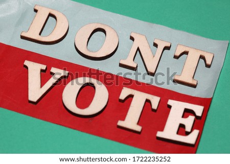 Text DONT VOTE on Polish national flag close up on green background