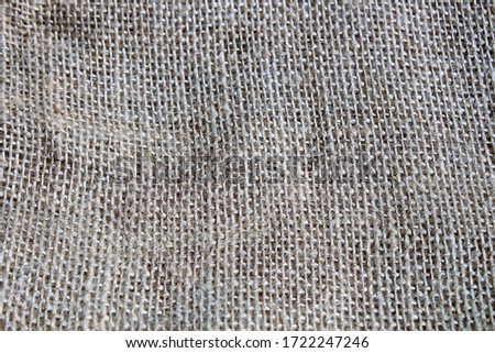 New burlap rustic grey material background and wallpaper with a free space for text, soft fabric organic natural texture as a nice backdrop for text or ecology objects, organic food, healthy lifestyle