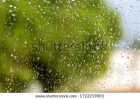 Large raindrops on windshield of car. Inside view. Selective photo. Abstract background
