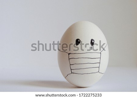 Eggs wearing medical mask for stop coronavirus and models of covid-19 virus on white background. Epidemic coronavirus COVID-19 concept. Place fo text Royalty-Free Stock Photo #1722275233