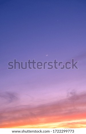 Crescent moon and Venus in a sunset sky 