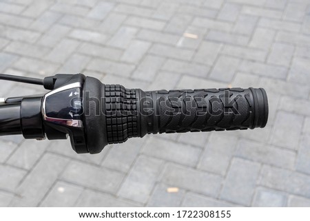 Close view of the right hand handle of a bicycle showing the gear changer