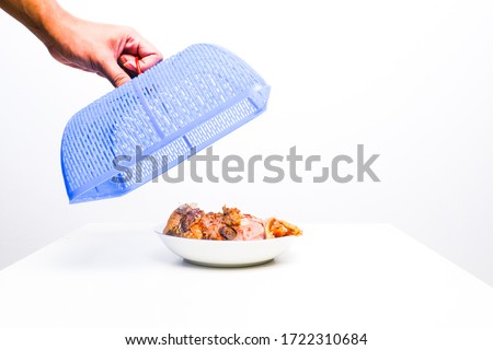 A picture of "tudung saji" or food cover with "asam pedas" or spicy sour soup under it. Royalty-Free Stock Photo #1722310684