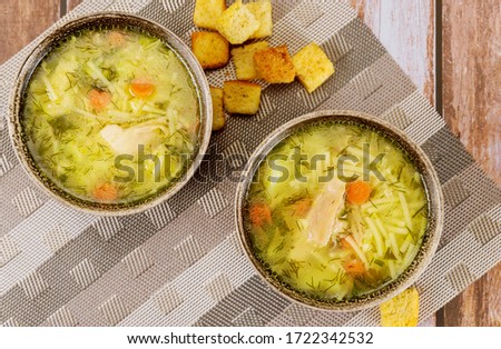 Chicken soup with noodles, potato, herbs and croutons.