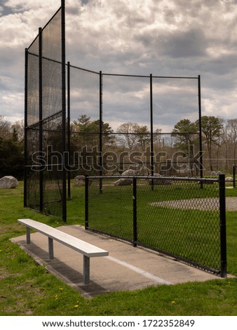 Empty youth baseball field bench