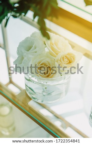 Beautiful wedding table setting with floral decorations and candels. Indoor wedding ceremony. Closeup details of a wedding decor