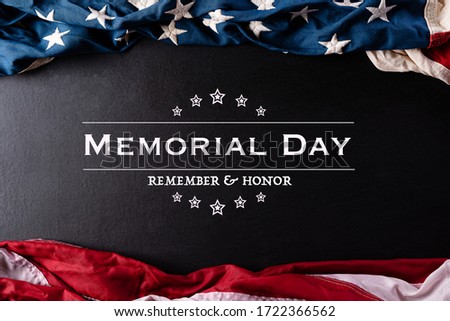 Happy Memorial Day. American flags with the text REMEMBER & HONOR against a black  background. May 25. Royalty-Free Stock Photo #1722366562