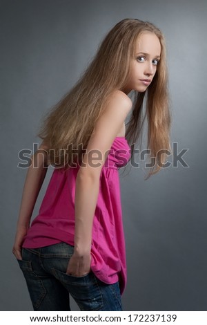 Beautiful girl model pose on gray background