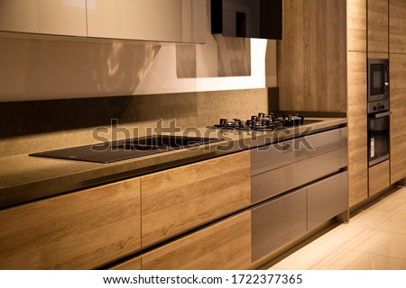 Interior of luxurious modern kitchen equipment, grey and oak cabinets Royalty-Free Stock Photo #1722377365