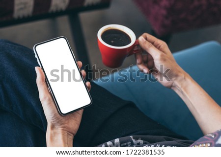 cell phone Mockup image blank white screen.woman hand holding texting using mobile on desk at coffee shop.background empty space for advertise.work people contact marketing business,technology 