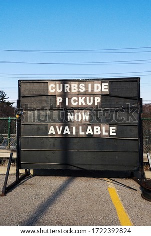 Sign with message announcement that contactless curbside pickup available during coronavirus epidemic. Shopping curb side pick up during social distance quarantine of covid-19 virus. 