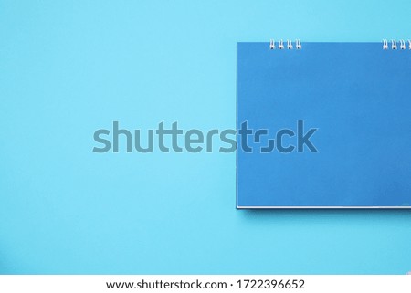 Empty blank calendar on blue background