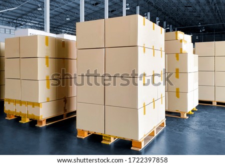 Stack of Package Boxes on Wooden Pallets. Interior of Storage Warehouse. Supply Chain. Cardboard Boxes. Cargo Shipment Export-Import. Shipping Warehouse Logistics.
