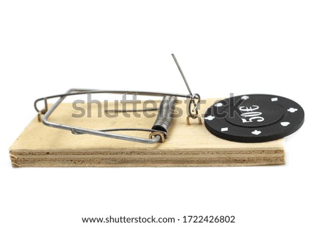 Poker Chip bait in a mousetrap is Isolated on white. Gambling Concept.