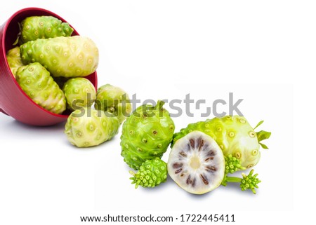 Closeup Noni fruits or Morinda citrifolia ( great morinda, Indian beach mulberry, cheese fruit ) and slice with seeds isolated on white background.  
