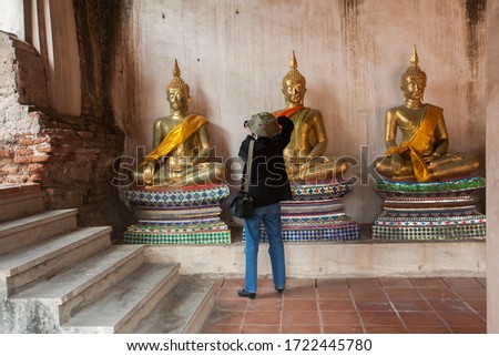 Tourist take a photo at Golden Buddha Statue at Wat Phutthaisawan, Thai Buddhism Temple, Ayutthaya, Thailand