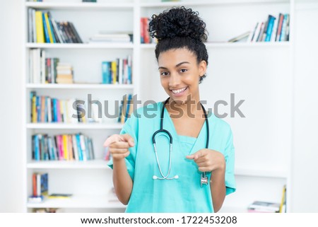 Laughing latin american female nurse or medical student at hospital