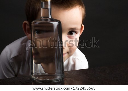 Portrait of a boy using a water bottle. The concept of curiosity