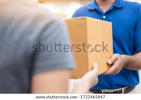 Woman hand accepting a delivery boxes of paper containers from deliveryman,Delivery concept. Royalty-Free Stock Photo #1722465847