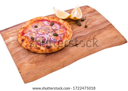 Pizza with tuna, onions and capers on a wooden dish, tray. The object is isolated on a white background.