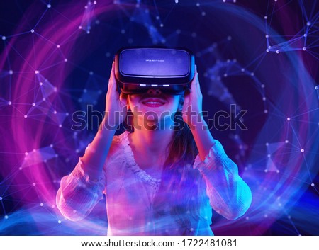 Woman with glasses of virtual reality. Future technology concept. Colorful neon lights. Royalty-Free Stock Photo #1722481081