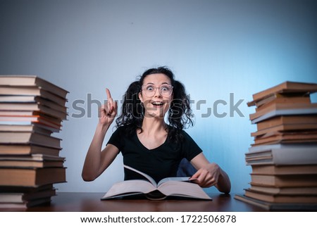 young girl reading very interesting book at home