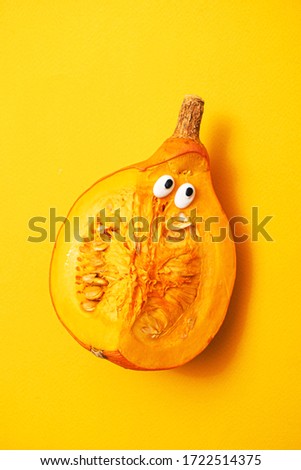 funny pumpkin on the yellow background
