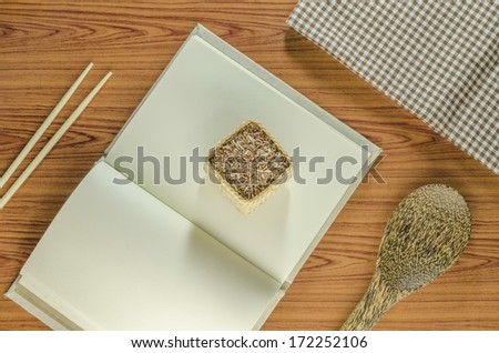 brown kitchen towel with spoon on wood background