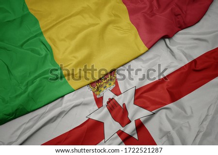 waving colorful flag of northern ireland and national flag of mali. macro