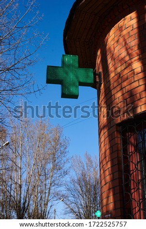green cross on the pharmacy building