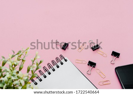 Stationery concept, Flat Lay top view Photo of pencil, pen  and notepad  on a pink abstract background with copy space, minimal style.
