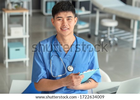 Male Asian doctor in clinic Royalty-Free Stock Photo #1722634009