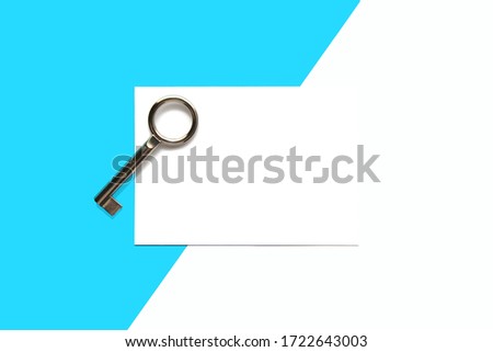 Key on blank card background, top view. blank frame photo. Minimal style with blue paper backdrop. concept for Real estate, Appreciation, feelings compliment, card greeting, mourning frame. Template