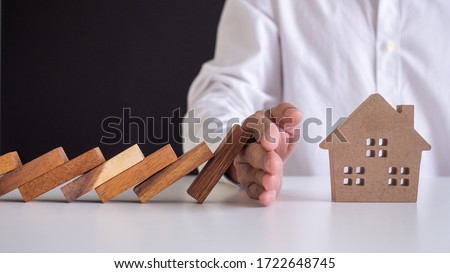 insurance with hands protect a house. Home insurance or house insurance concept Royalty-Free Stock Photo #1722648745