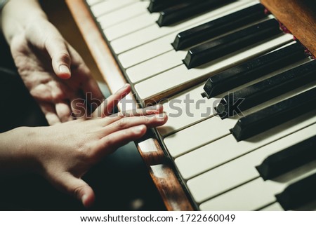 children's hands play the piano