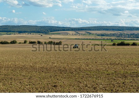panorama view of a field with hills and blue sky