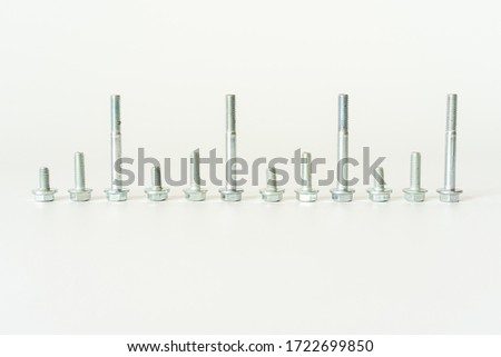 Steel bolts arranged in order, isolated on white background. Tool for maintenance work. Locking devices.