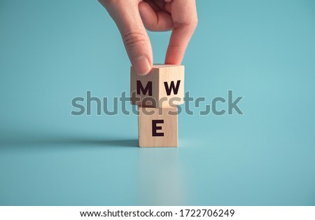 Hand flip wood cube with me or we on blue background, copy space. Royalty-Free Stock Photo #1722706249