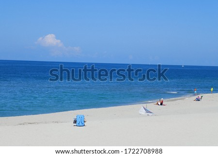 White sand beach with Waves and a blue sunny sky