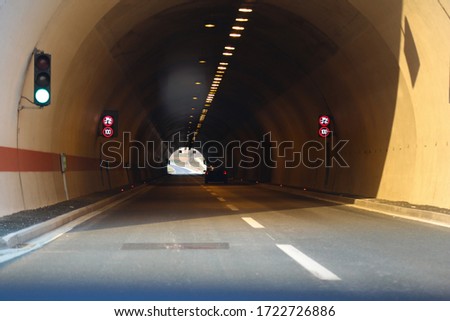Car in tunnel on highway road