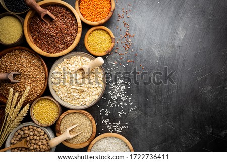 Organic products. Bowls with different gluten free grains on black background, top view