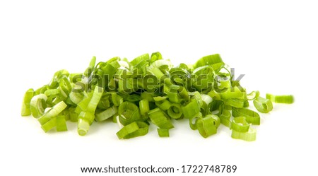 Pile of fresh chopped spring onion over white background